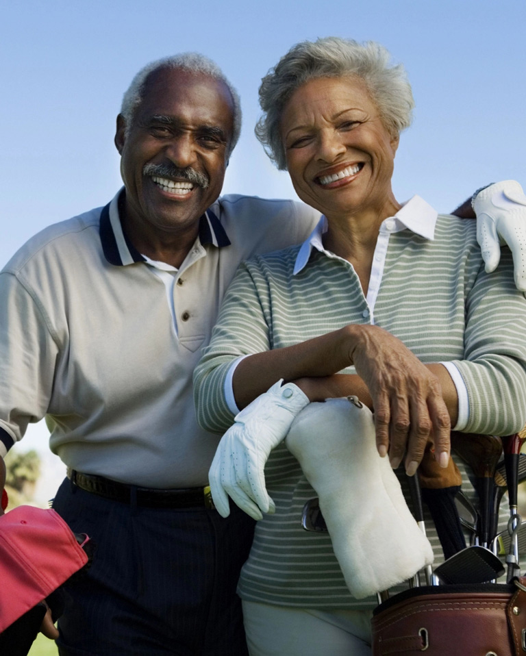 Happy retired couple on golf course