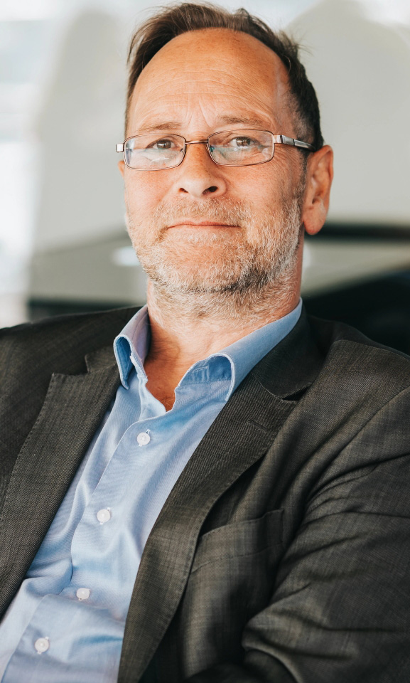 Middle aged man with stoic smile