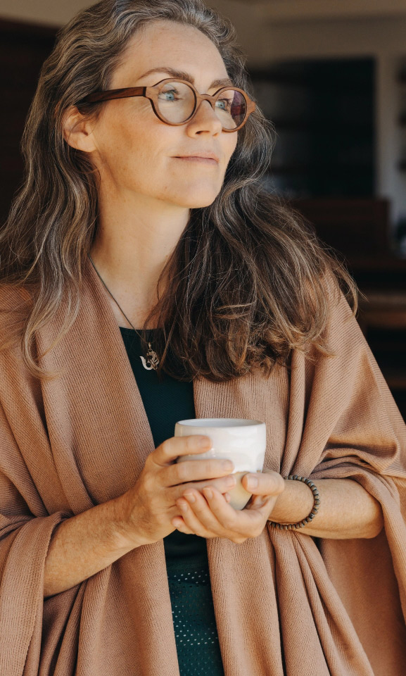 Middle aged woman looking out window