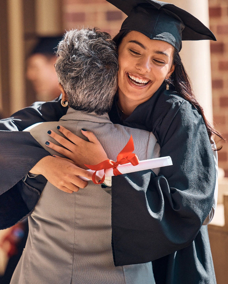 Mom and daughter hugging daugters graduation