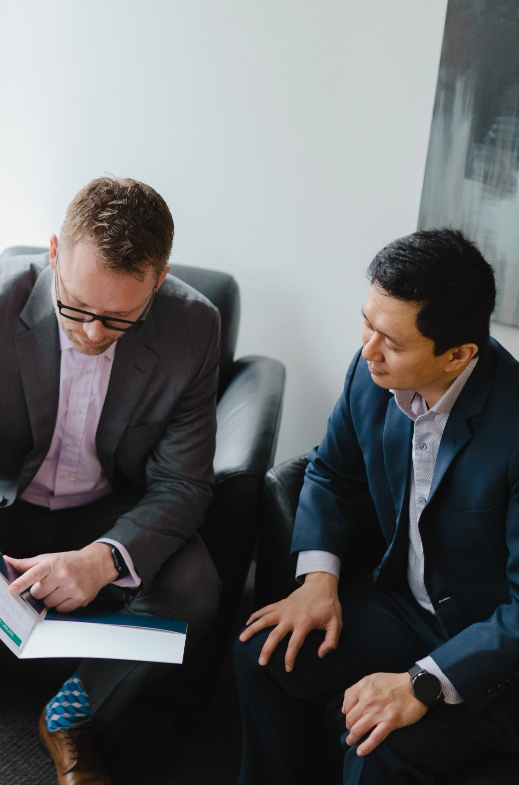 Advisor with client showing portfolio plan