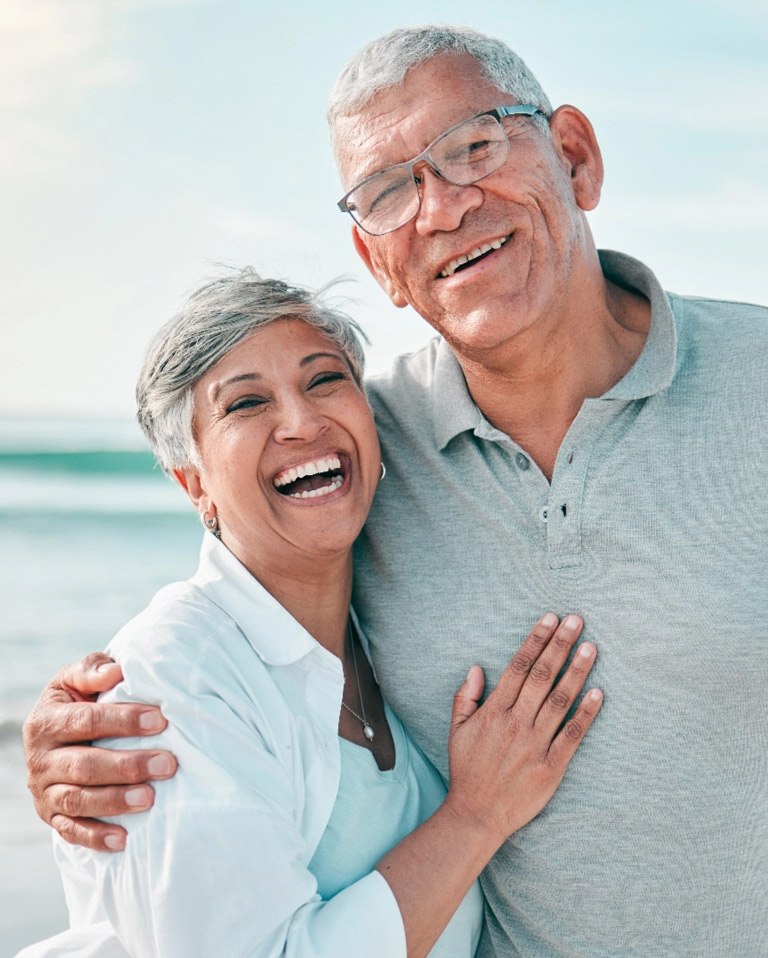 Happy retired couple on beach
