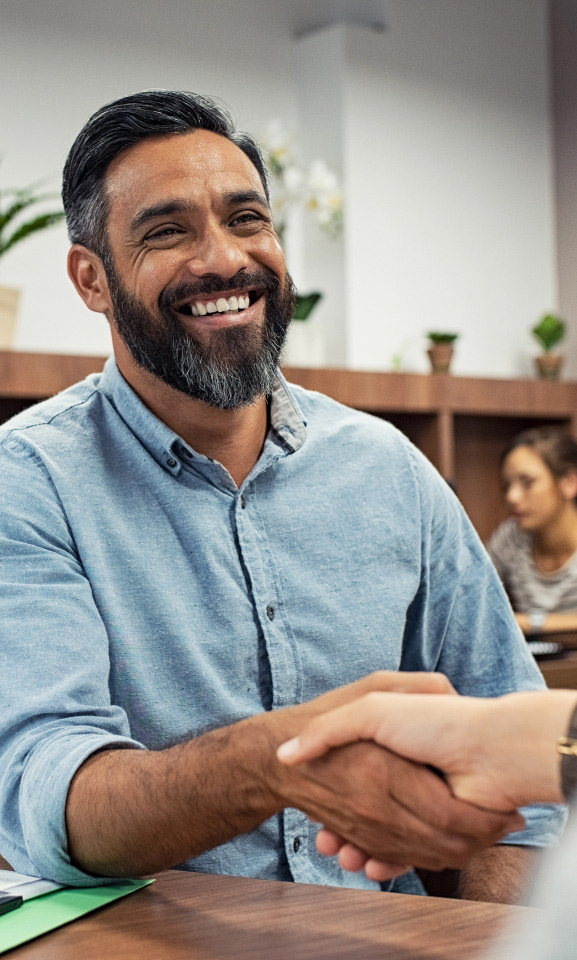 Middle aged man shaking hands with advisor