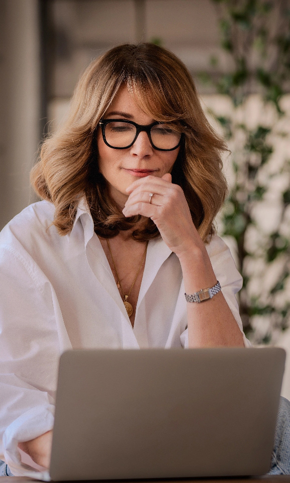 Middle aged woman reviewing strategy with laptop