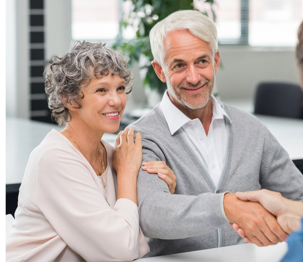 Smiling retired couple tablet