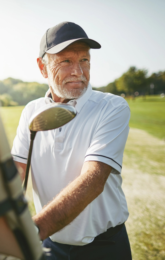 Successful older man golfing