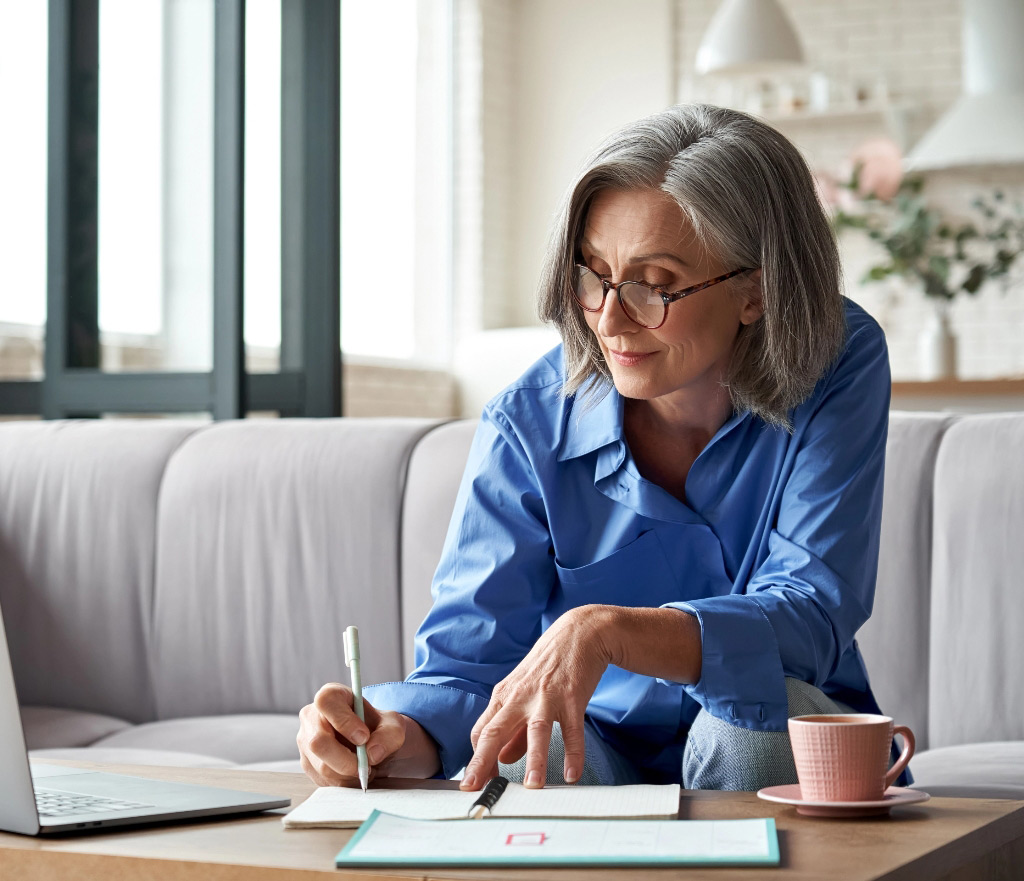 Successful older woman planning tablet