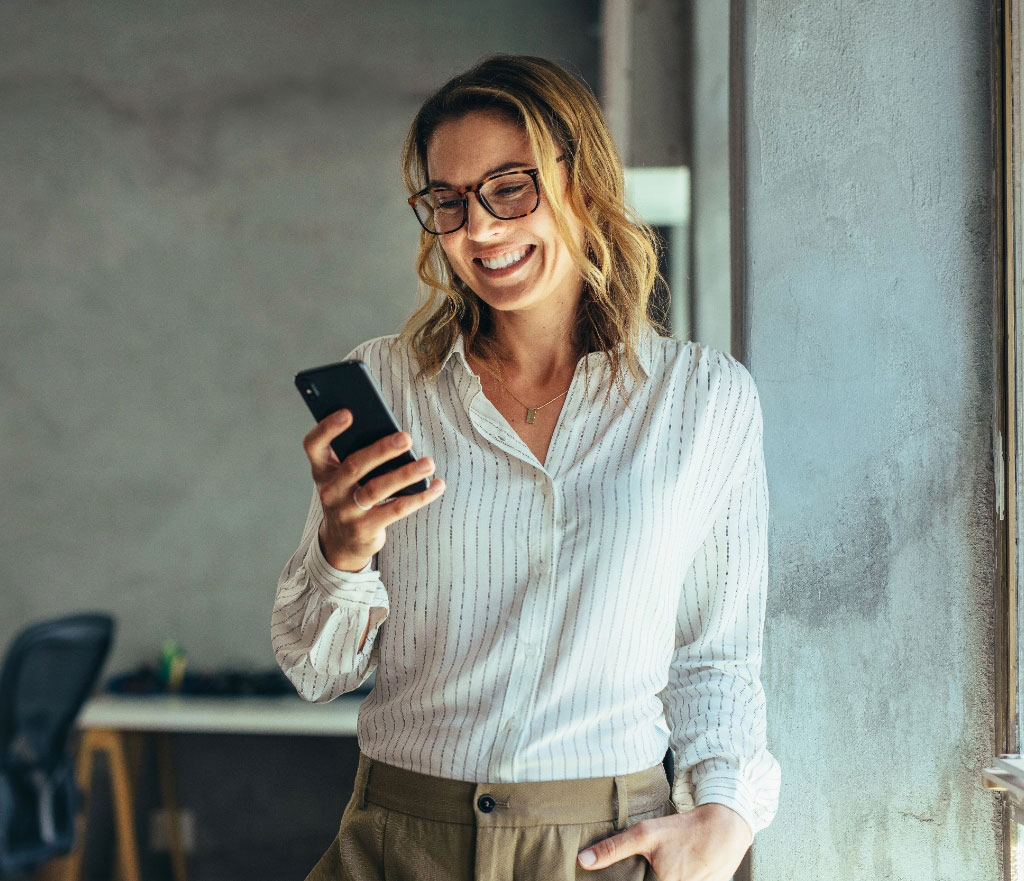 Successful woman smiling with phone tablet