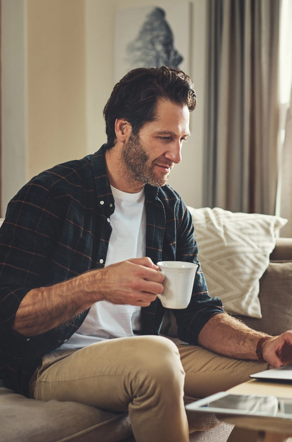 Young man with coffee reviewing financial plan